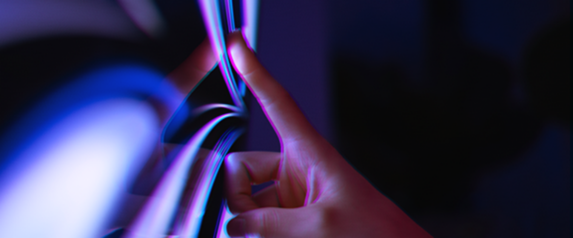 A person’s hand making contact with a digital touchscreen, highlighting the interaction between human and technology.
